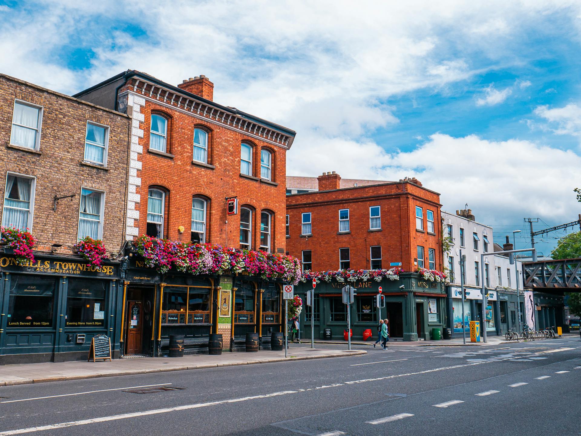 Colorful Georgian brick buildings lining Dublin's Merrion Square under soft light
